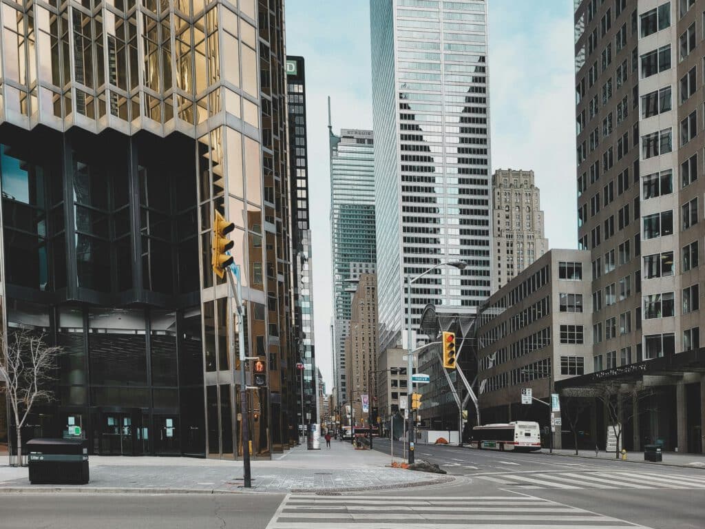 A city street with tall buildings in the background.